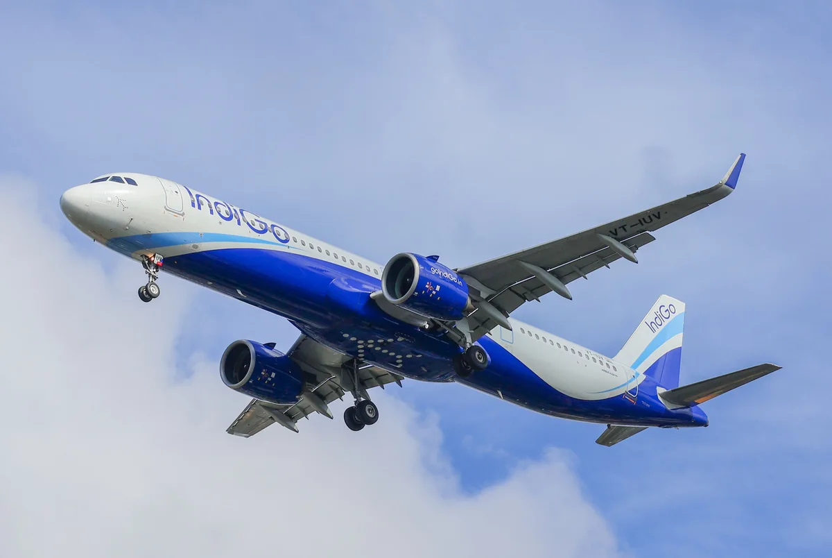 IndiGo aircraft in flight against a blue sky